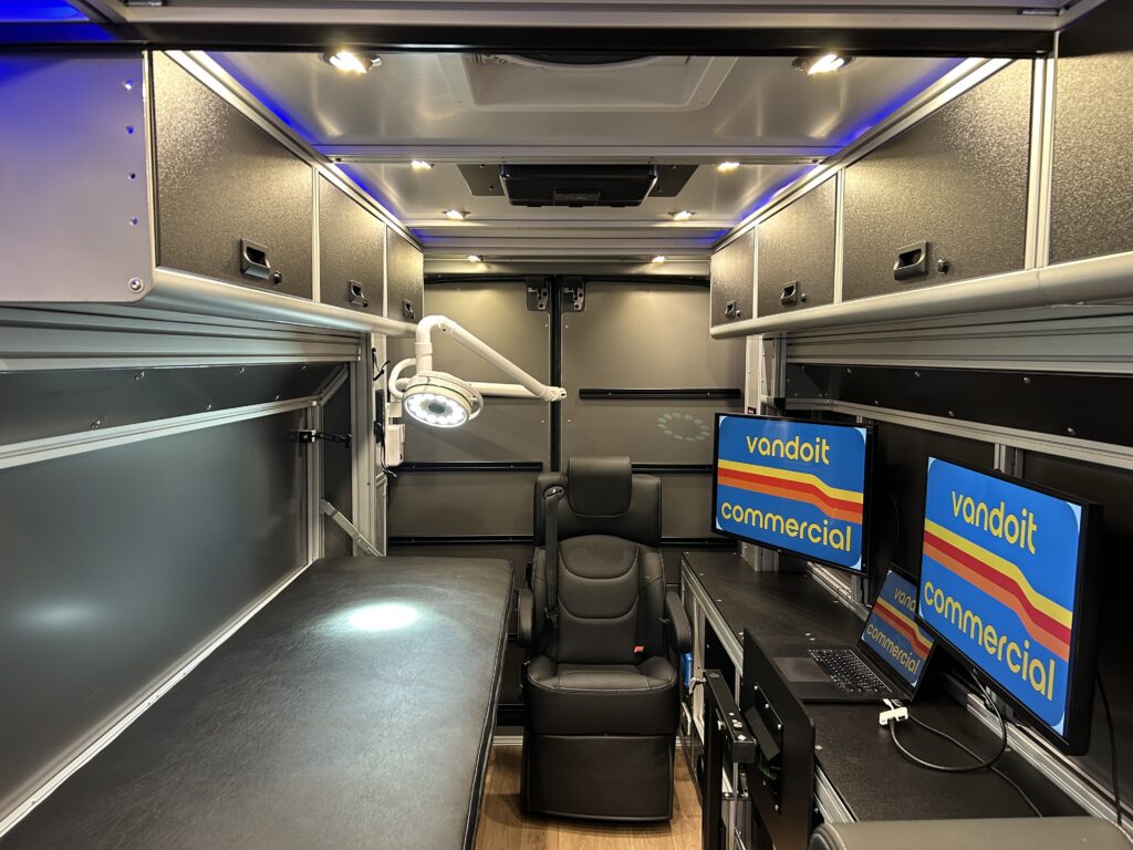 Vandoit unit with a padded exam table, articulating exam light, captain chair and clinician workstation